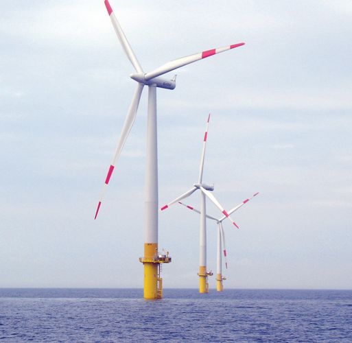 Three windmills at sea